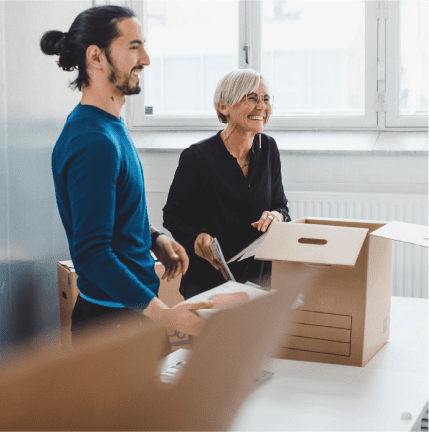 people in white room opening boxes