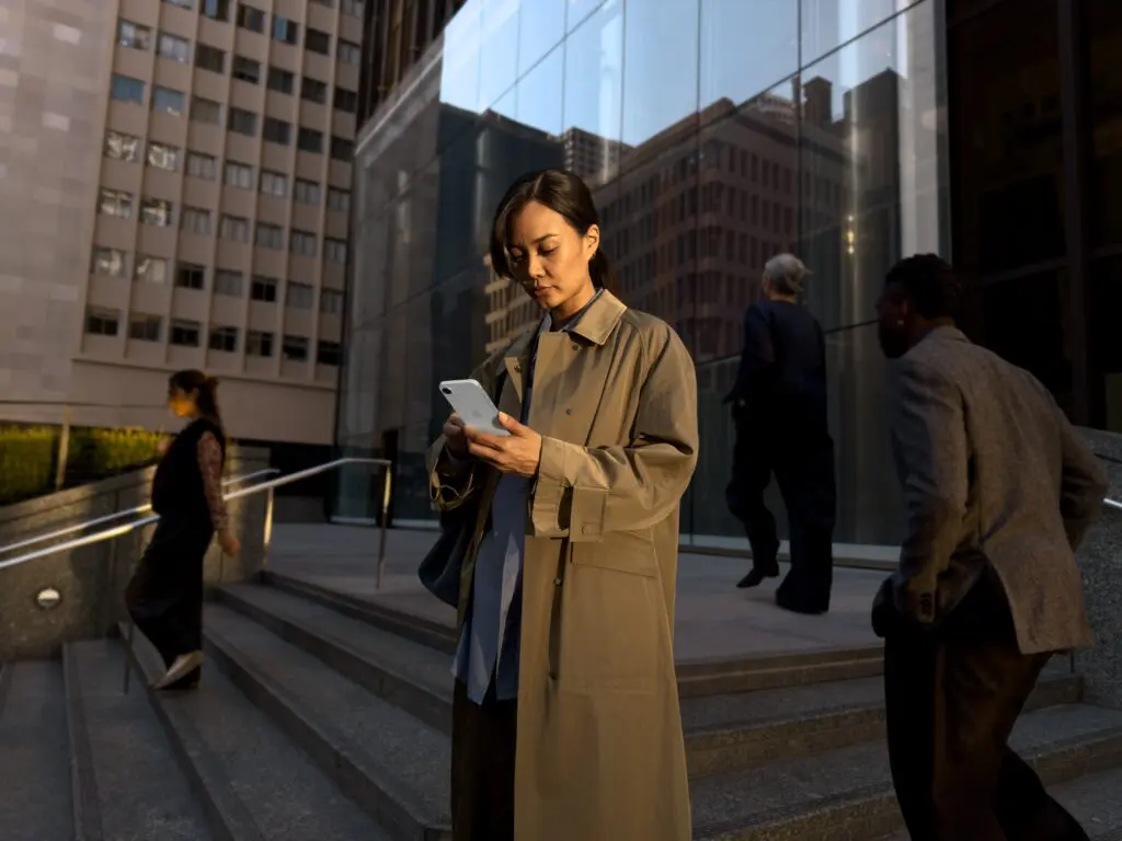 woman-using-apple-iphone-city-street