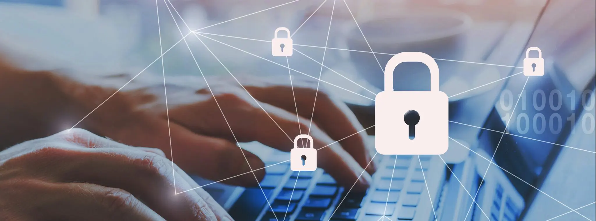 Cybersecurity: Hands typing on laptop with lock icons.