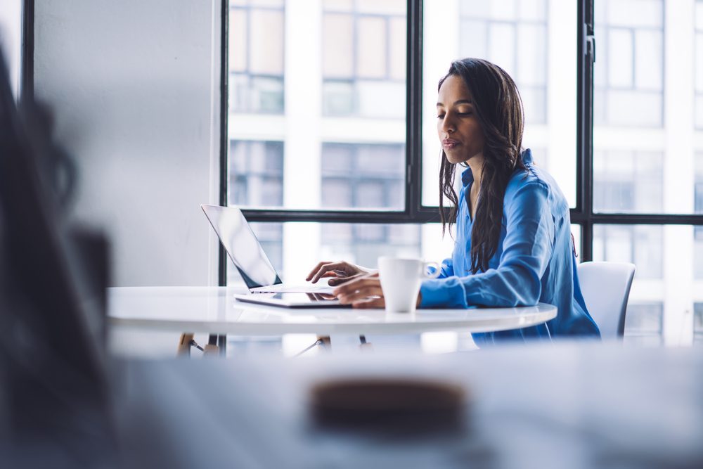Selective,Focus,Of,Serious,African,American,Woman,Using,Laptop,And