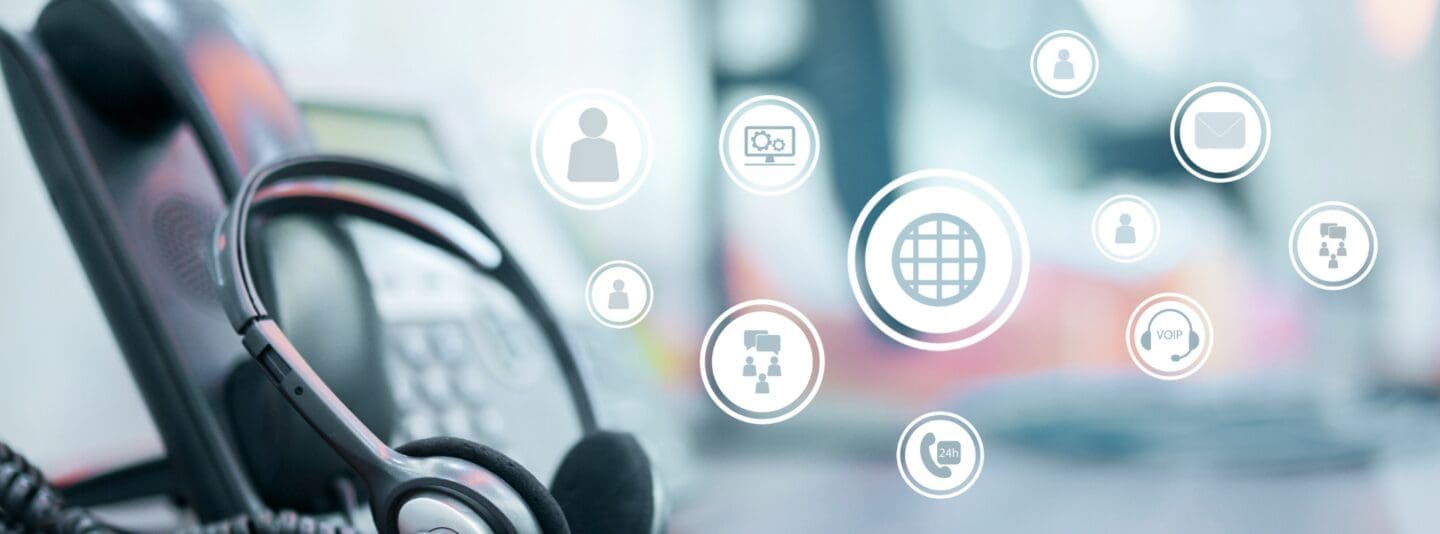 VoIP headset on desk with cloud icons