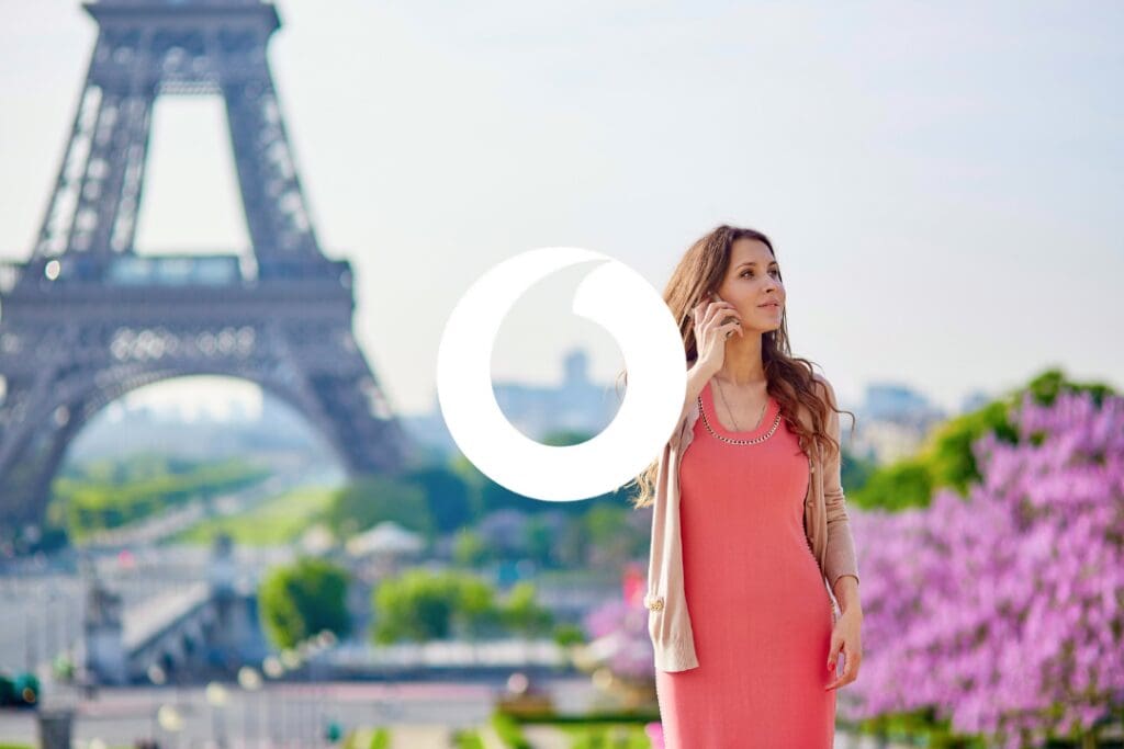 Vodafone Roaming - Woman on phone in Paris with Eiffel Tower and pink blossoms